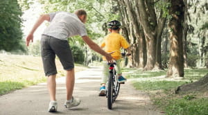 How to start family cycling - boy learning to ride a bike